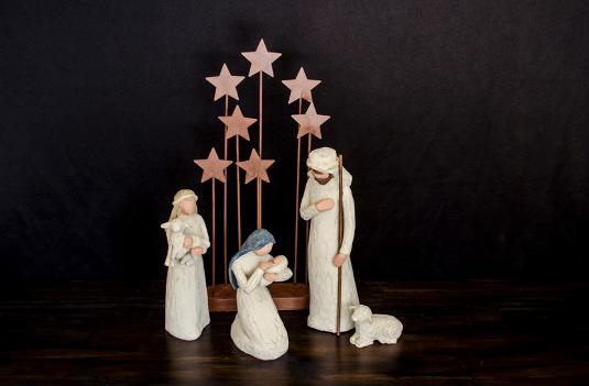 A nativity scene: Mary, Joseph, a shepherd, two lambs, some stars