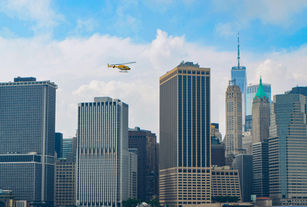 City skyline with tall buildings and yellow helicopter