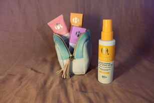 Cosmetic products with a pouch on a brown background.