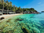 Mong Tay Island, Phu Quoc. View of a tranquil turquoise lagoon with palm trees. An ideal spot for relaxation and an exclusive stop during Kimi Tours trips