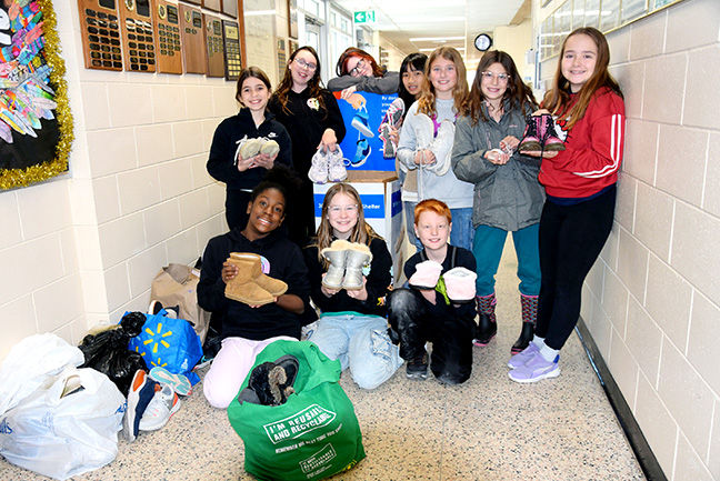 Amherstburg Public School students show pairs of shoes they are gathering for Soles4Soles. The school is attempting to gather a total of 10,000 pairs of shoes.