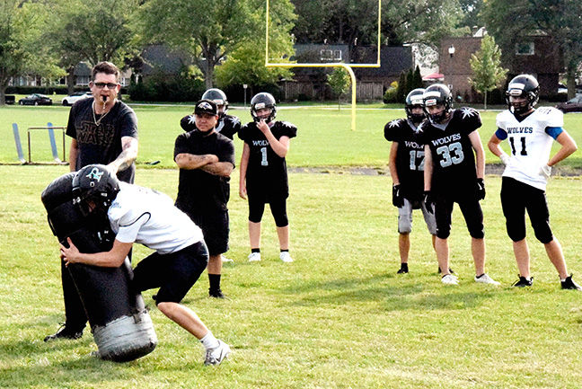 North Star coach Joel Charron (left) works with players on a drill last Wednesday afternoon during training camp at H. Murray Smith Centennial Park.