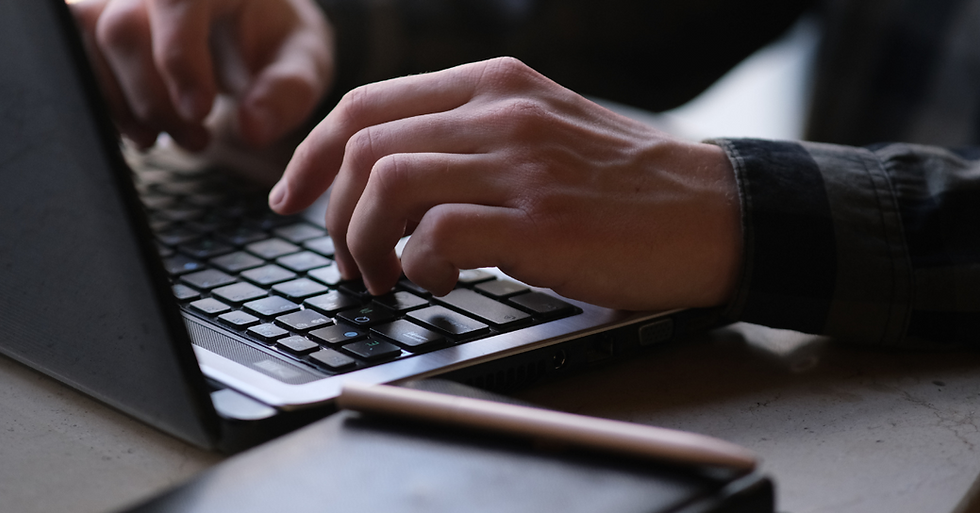 person typing on a laptop