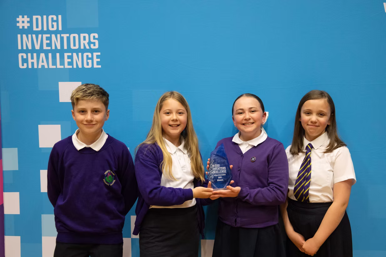 Winning team posing for photo with their award