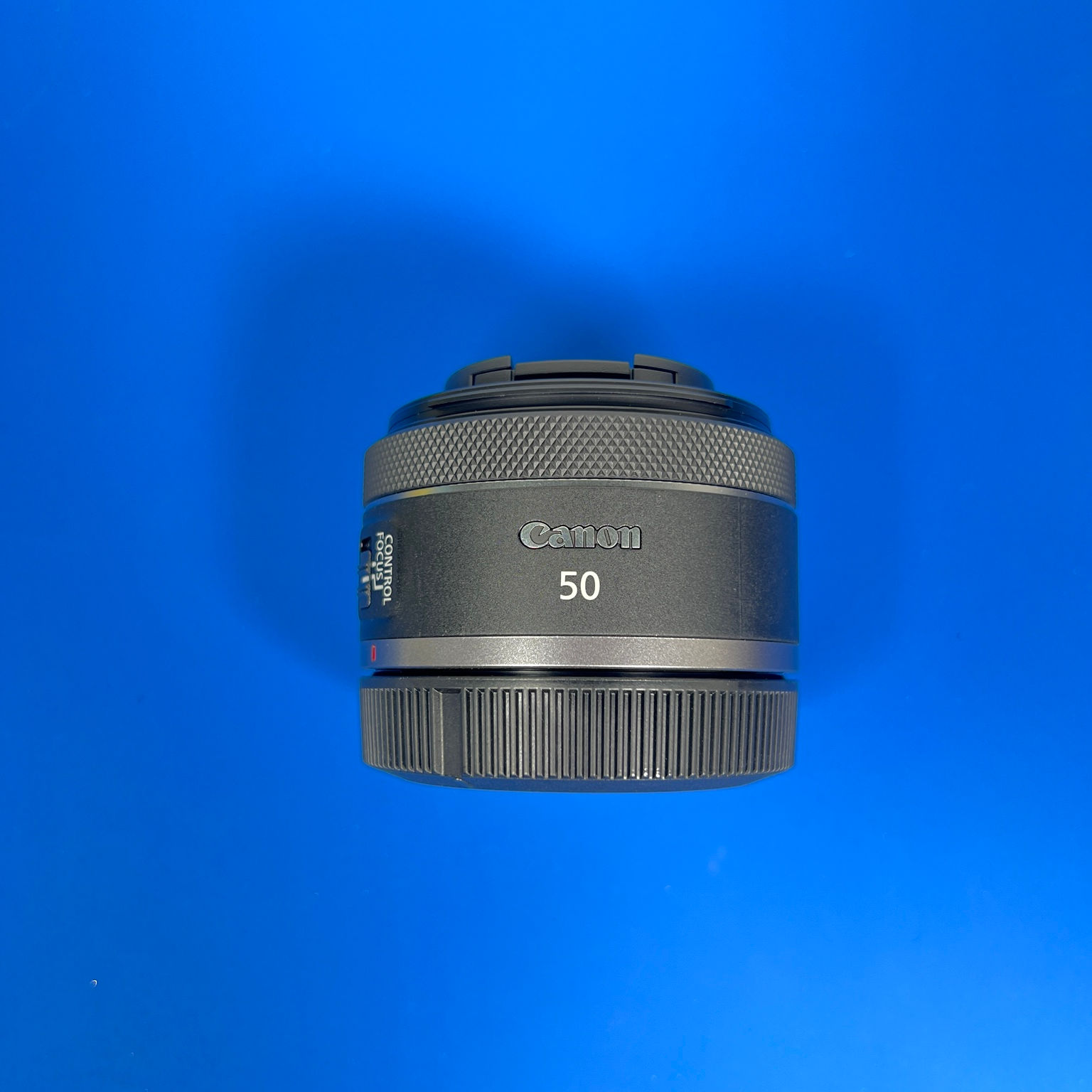 Canon RF 50mm f/1.8 STM lens side view with front cap