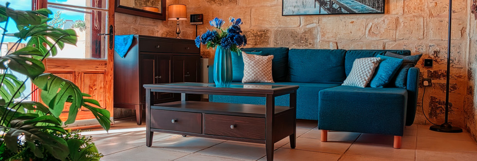 Beautifully decorated elegant living rooms at Farmhouse Cala Gozo, showcasing chic decor and comfortable seating for socializing and relaxation.