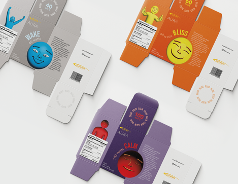 Three Glowbee unfolded packages splayed out. One is blue and grey for "Wake", a second is purple and red for "Calm", and a third is yellow and orange for "Bliss"