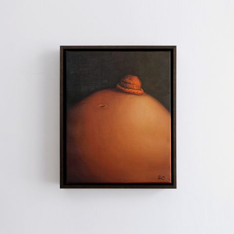 Oil painting of a pregnant belly, against a dark background, with a small orange crochet hat resting at the top close to the belly button