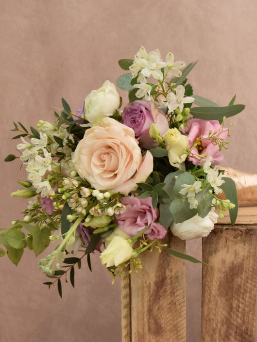 Pastel bridal bouquet made by an Oxfordshire florist. Peach, pink and white wedding colour scheme.