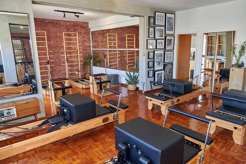 Reformer pilates studio interior at No.75space in Limassol with wooden equipment and mirrored walls