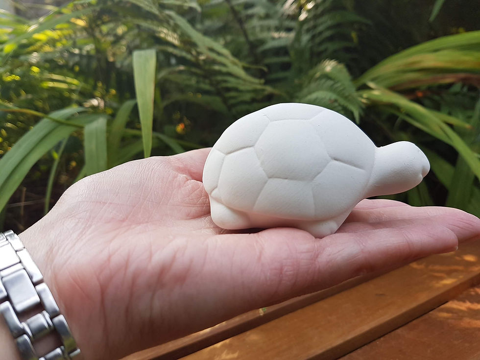 Thumbnail: Tortoise ceramic figure in hand for scale