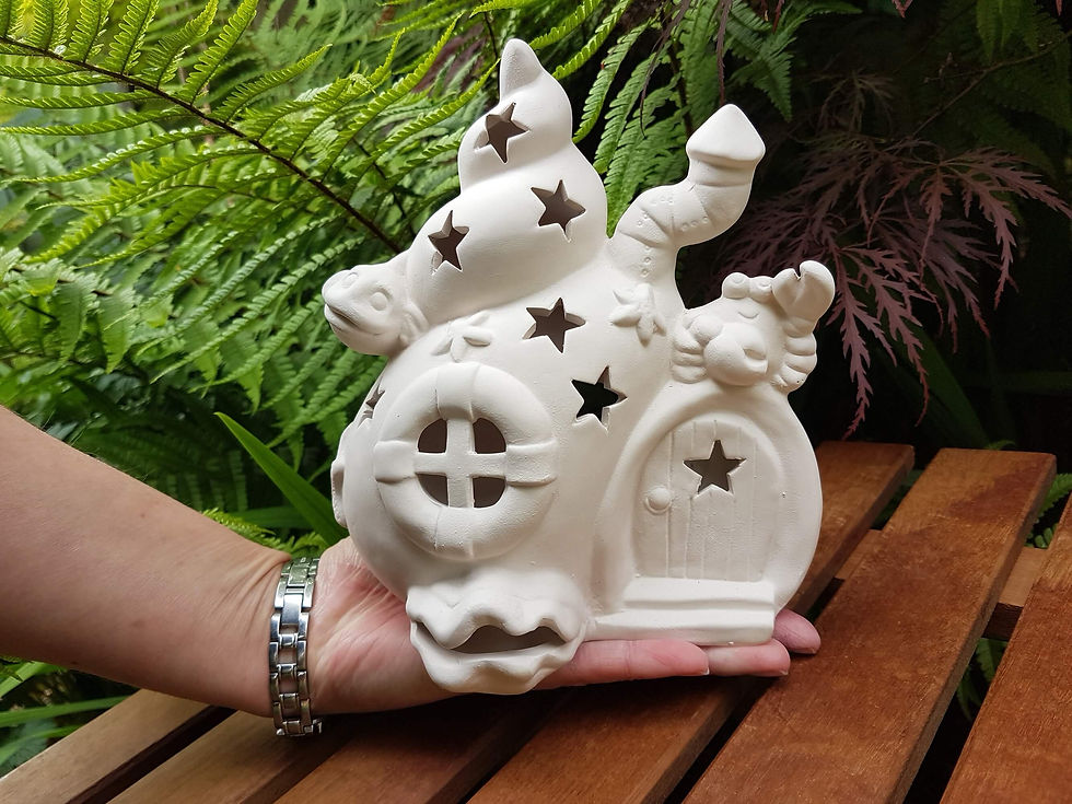 Thumbnail: Ceramic bisque shell house tealight lantern in hand for scale