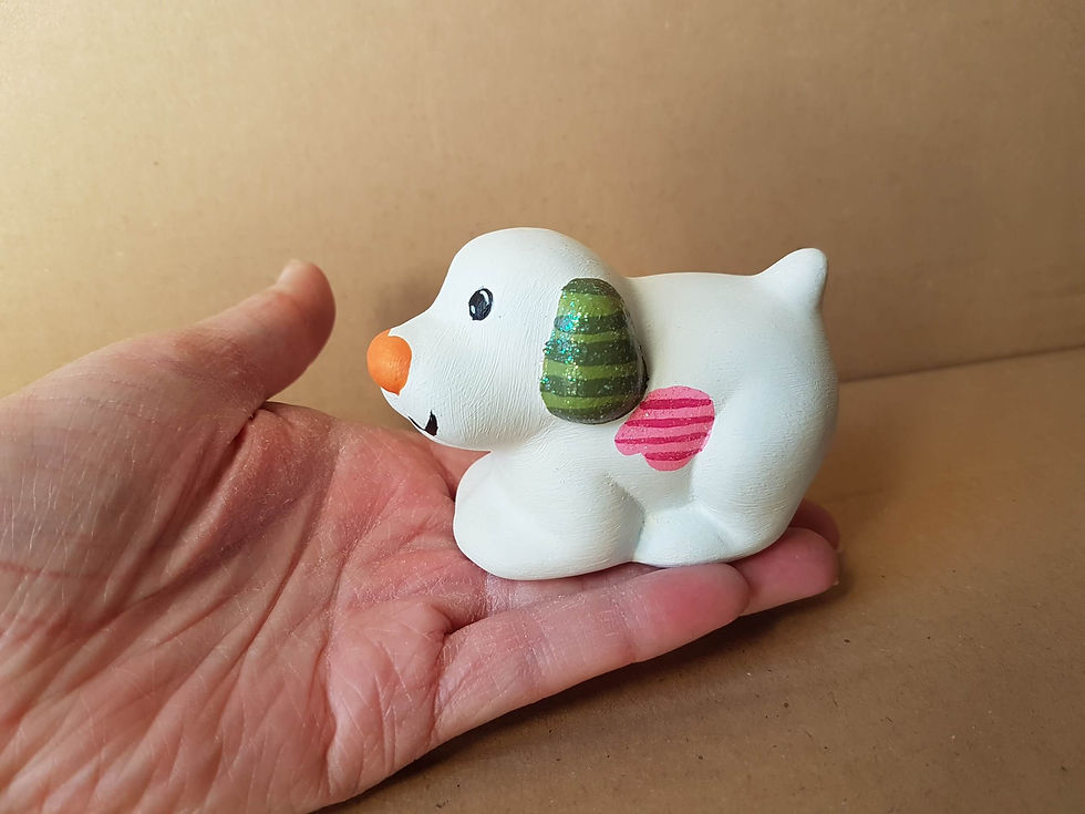 Thumbnail: Hand painted snowy dog ceramic figure in hand for scale