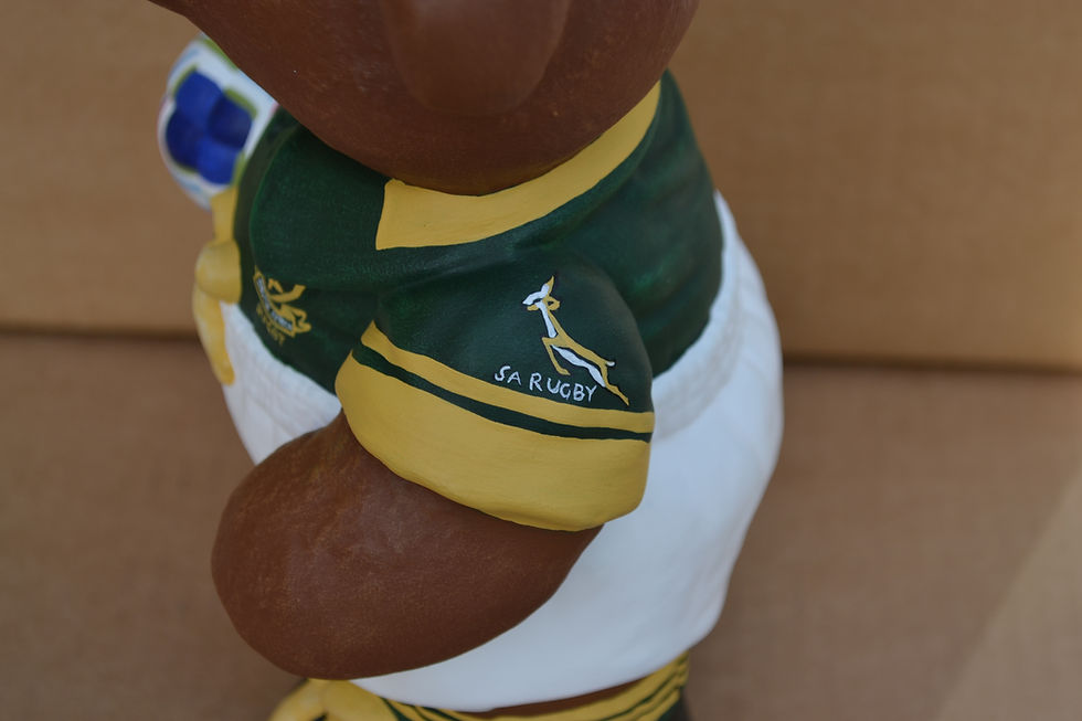 Thumbnail: Hand painted ceramic teddy bear with rugby ball & kit figure in South Africa international kit close up