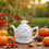 Thumbnail: Ceramic apple teapot in an autumnal orchard