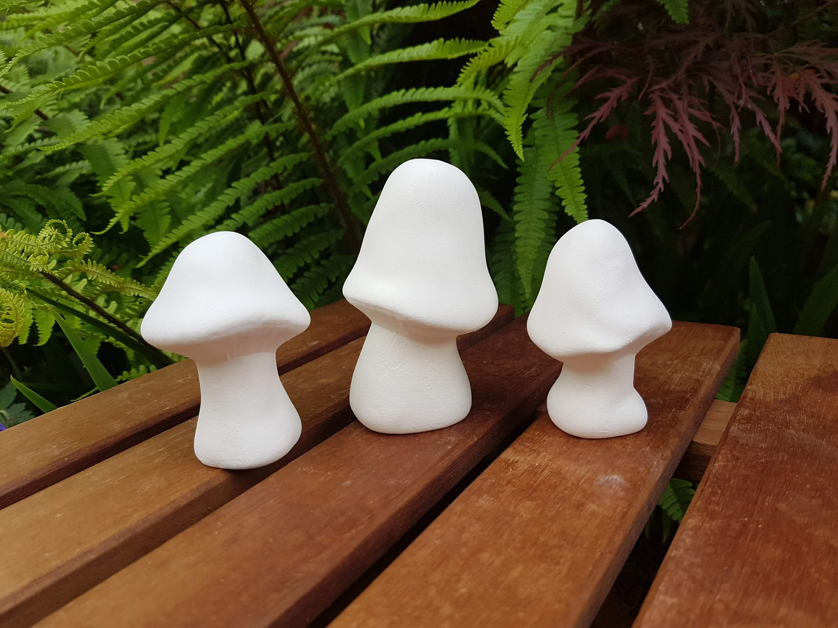 Ceramic bisque trio of mushroom figures front view