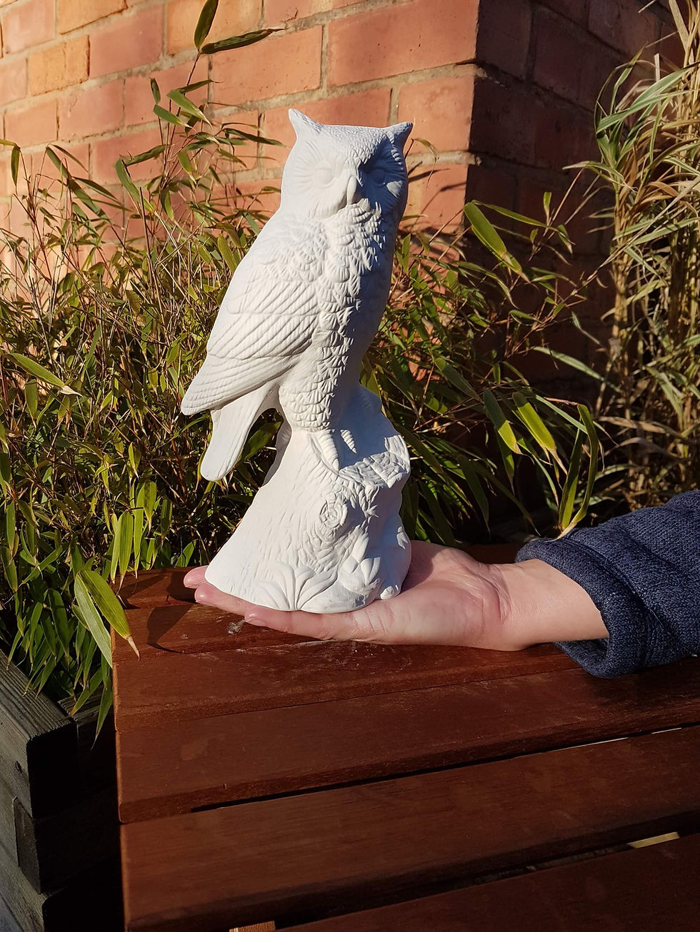 Thumbnail: Ceramic owl on log figure in hand for scale