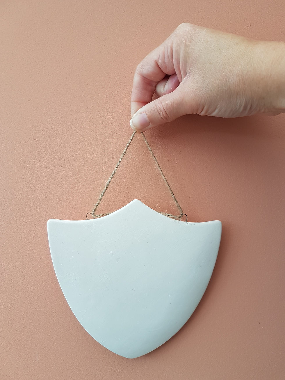 Thumbnail: Ceramic shield shaped 2d hanging plaque with hand for scale