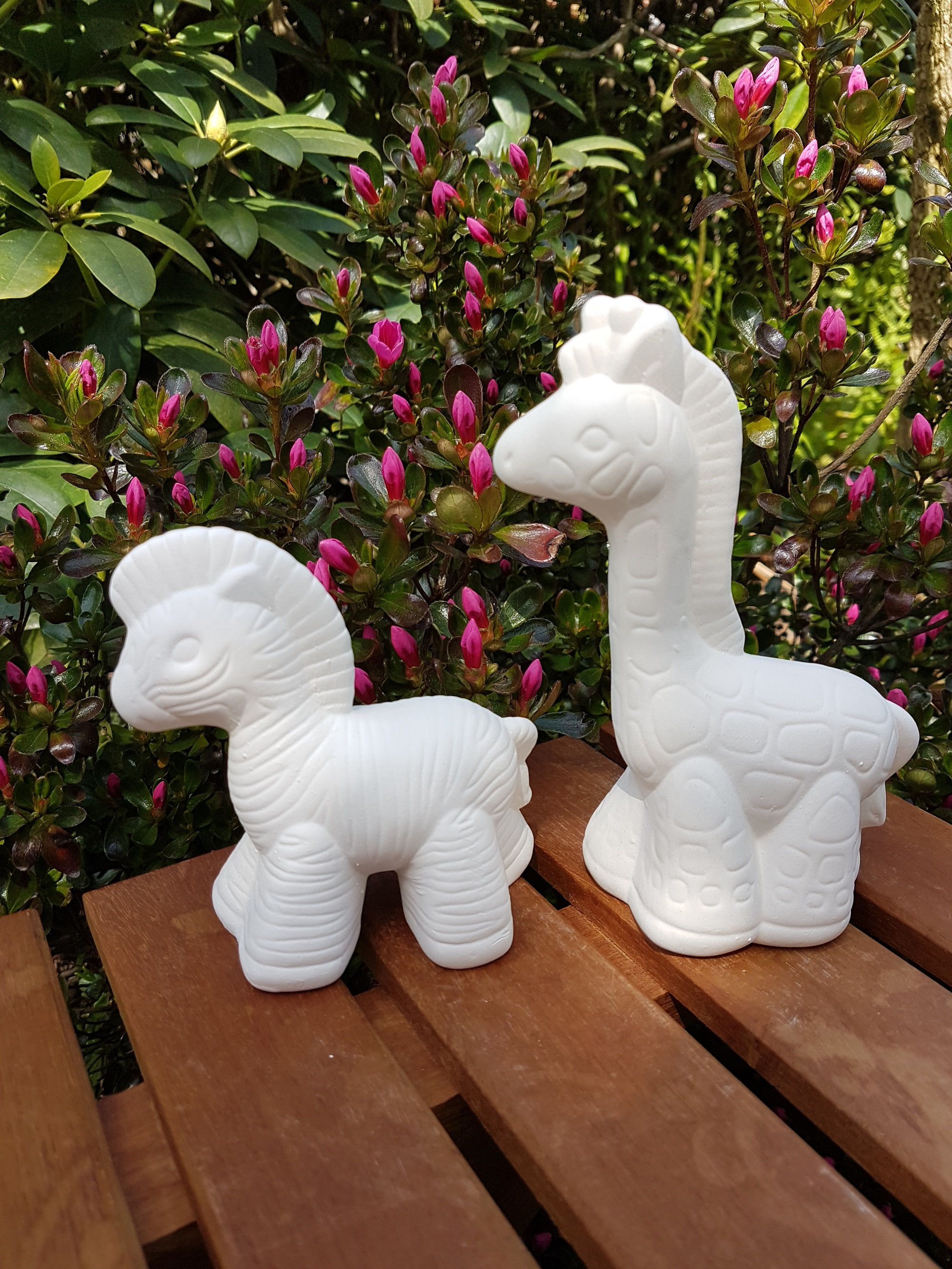 Zebra and giraffe set of ceramic bisque figures left side view