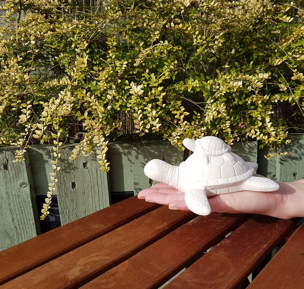 Thumbnail: Turtle and baby ceramic figure in hand for scale