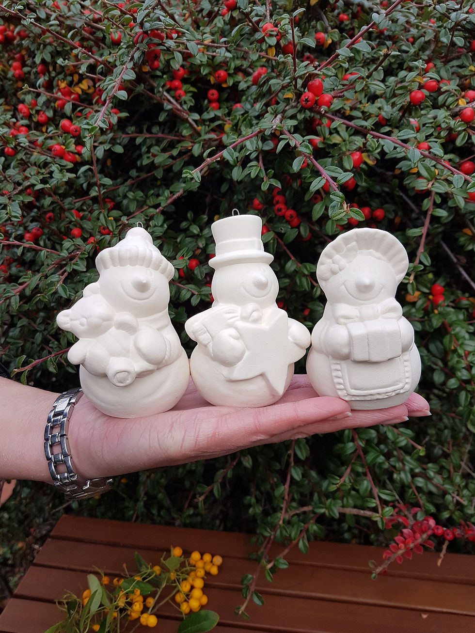 Thumbnail: Set of 3 victorian style snowmen ceramic bisque baubles in hand for scale