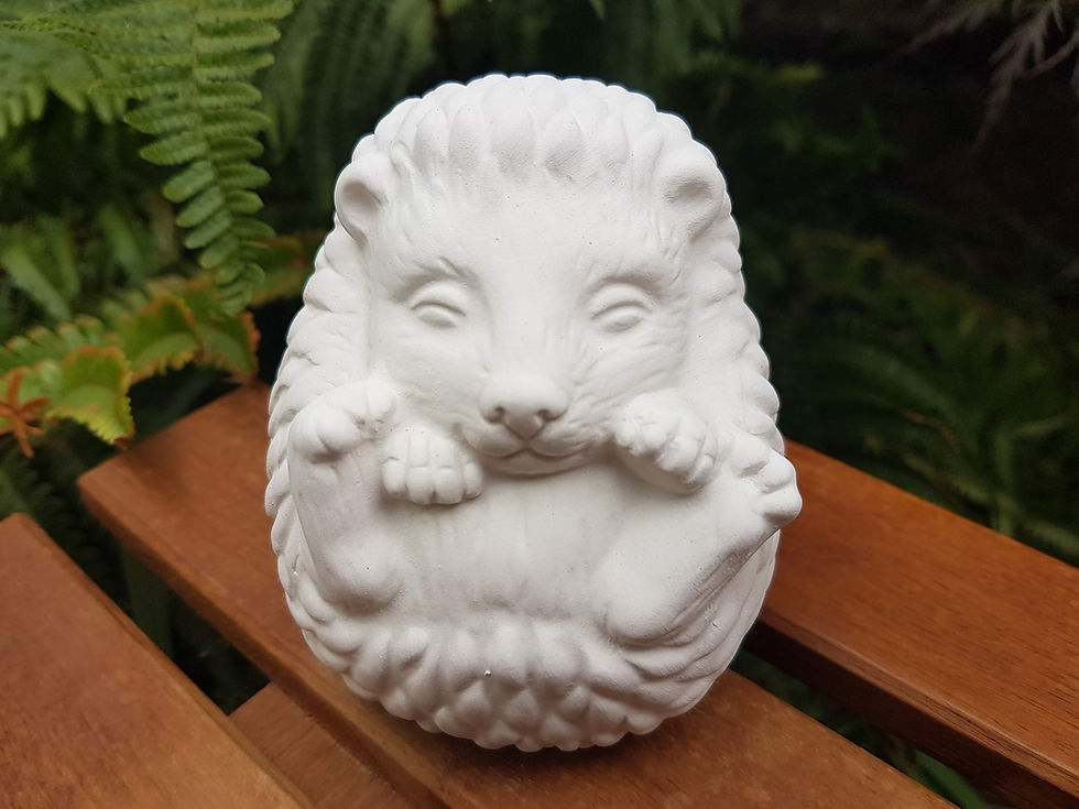 Ceramic bisque curled up hedgehog figure front view