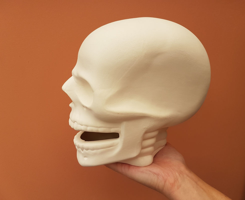 Thumbnail: Ceramic life sized human skull figure in hand for scale