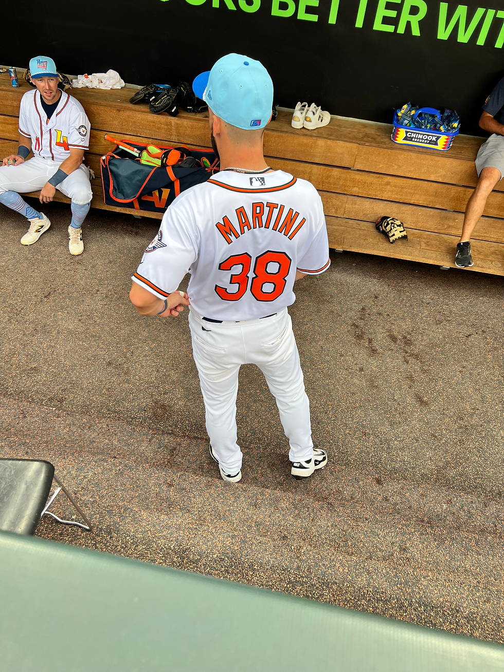 Las Vegas outfielder Nick Martini (#38) chats in the dugout with teammate Brett Harris (#11). Photo Credit: Terrel Emerson/Talk That Talk Media