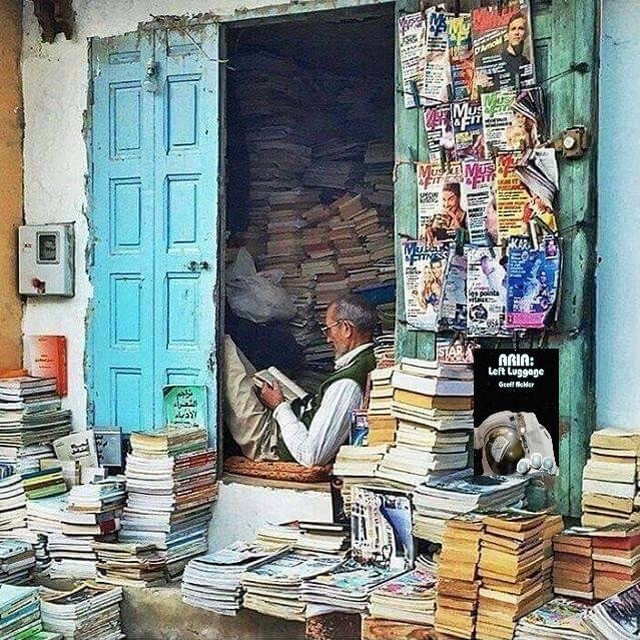 Indian bookshop owner reading.