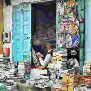 Indian bookshop owner reading.