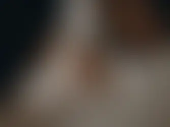 Newborn baby Aarohi sleeping peacefully, cradled tenderly in her parents' arms during her photoshoot