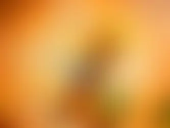 can of Zinga orange drink in a dynamic splash of liquid with fresh oranges on a vibrant background.