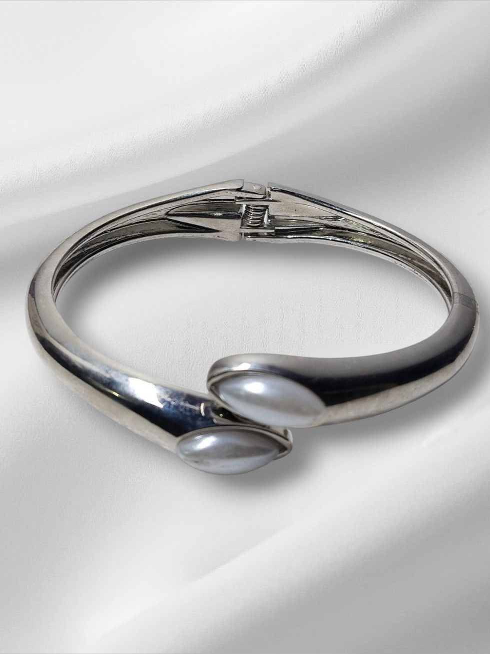 Silver bracelet with pearl accents, Thin size openable Kada, against white silk fabric.