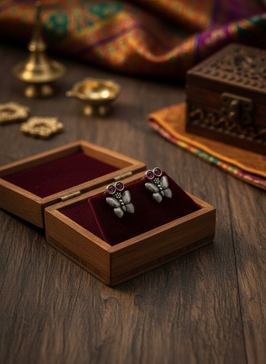 Silver earrings in a wooden box, Zirconia Gold Colour Earring, on a wooden table. Lavish Jewellery