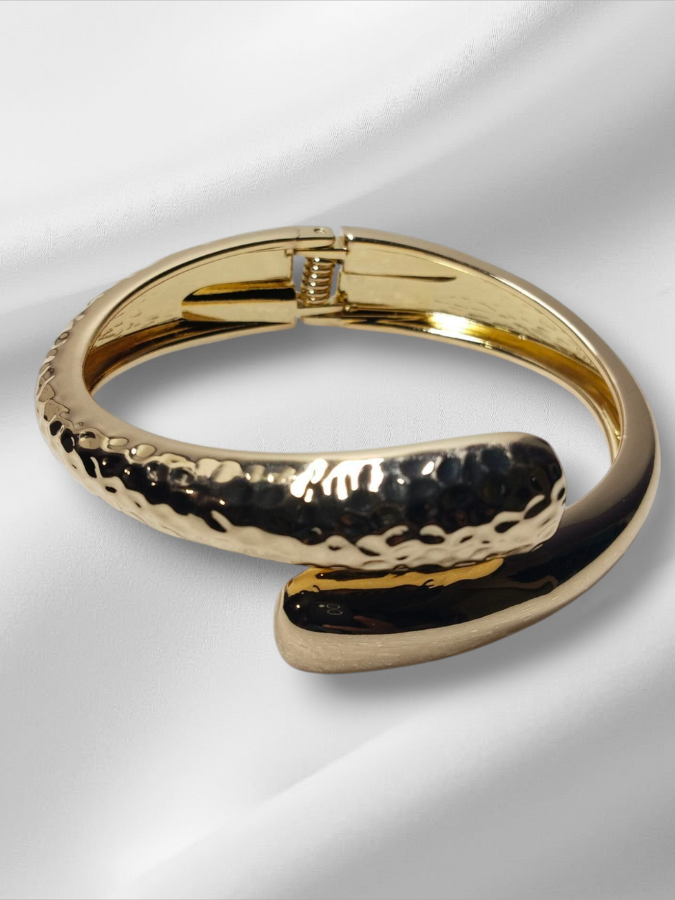 Golden bangle bracelet on white background. Lavish Jewellery. Stylish accessory for customers.