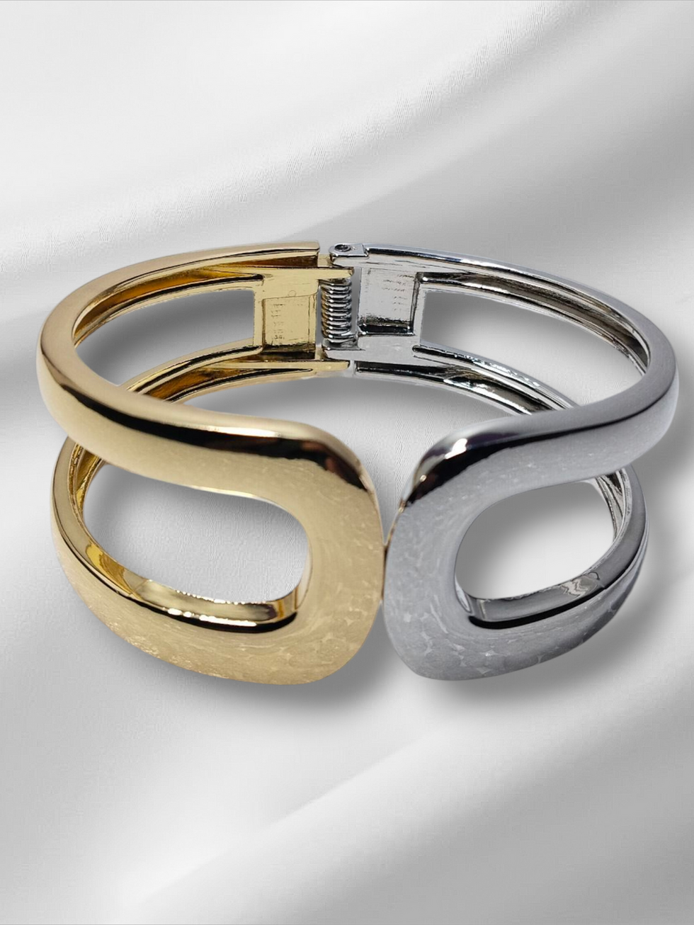 Gold and silver bracelet on white satin background. Thin size openable Kada. Lavish Jewellery.