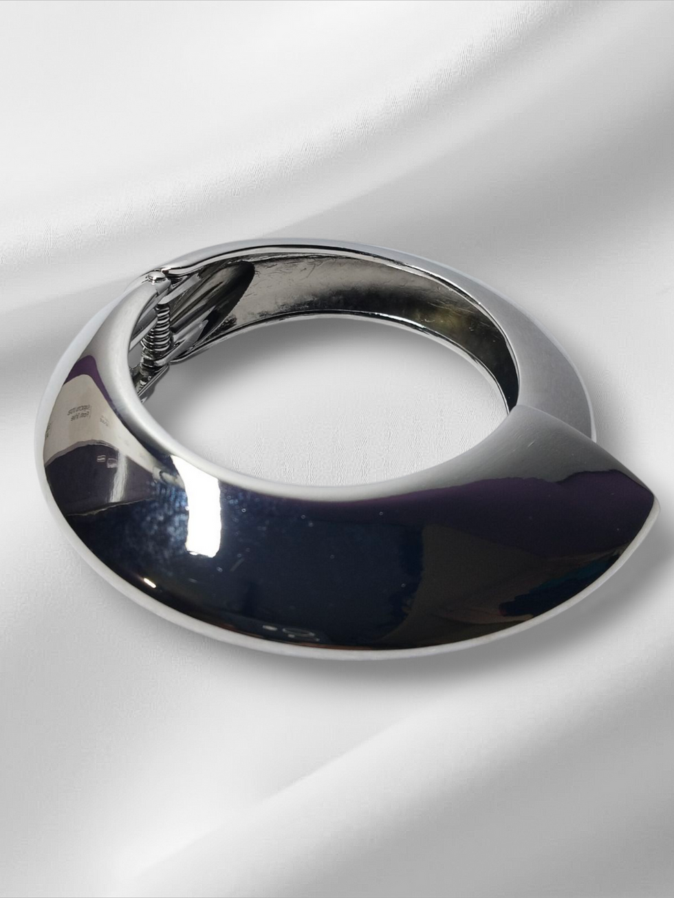 Modern silver bracelet on white background, Lavish Jewellery.