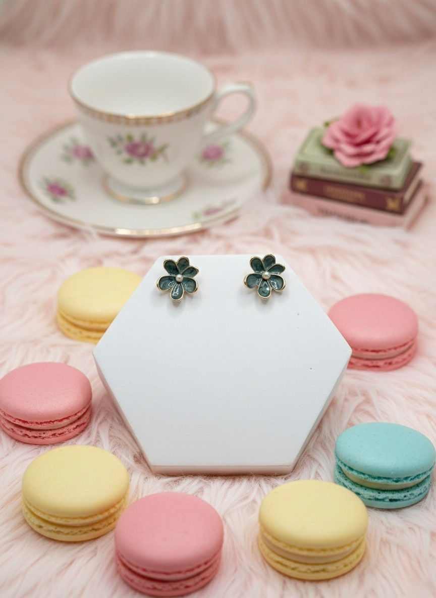 Floral earrings on display with pastel macarons and teacup in the background. Lavish Jewellery
