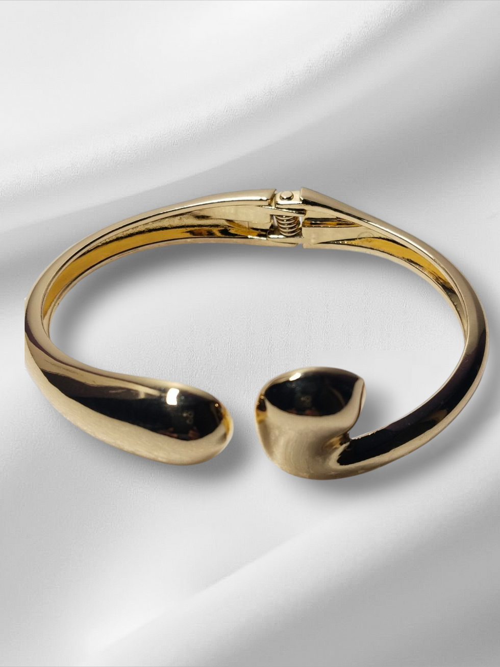 Golden bracelet on white silk, elegant Lavish Jewellery, open design