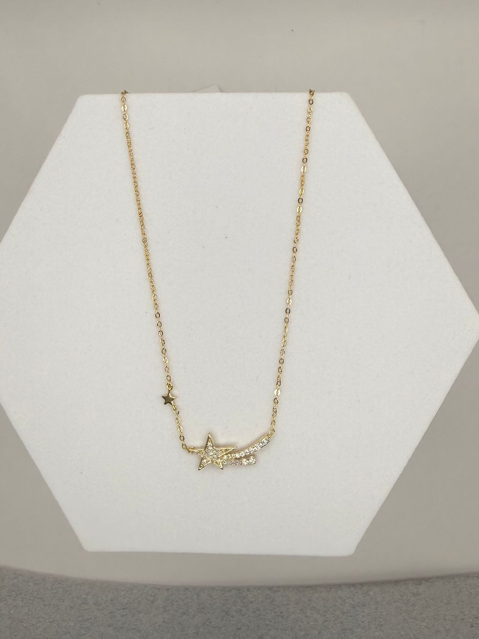 Gold necklace on white stand. Evil Eye Pendant Gold Polish Necklace. Lavish Jewellery