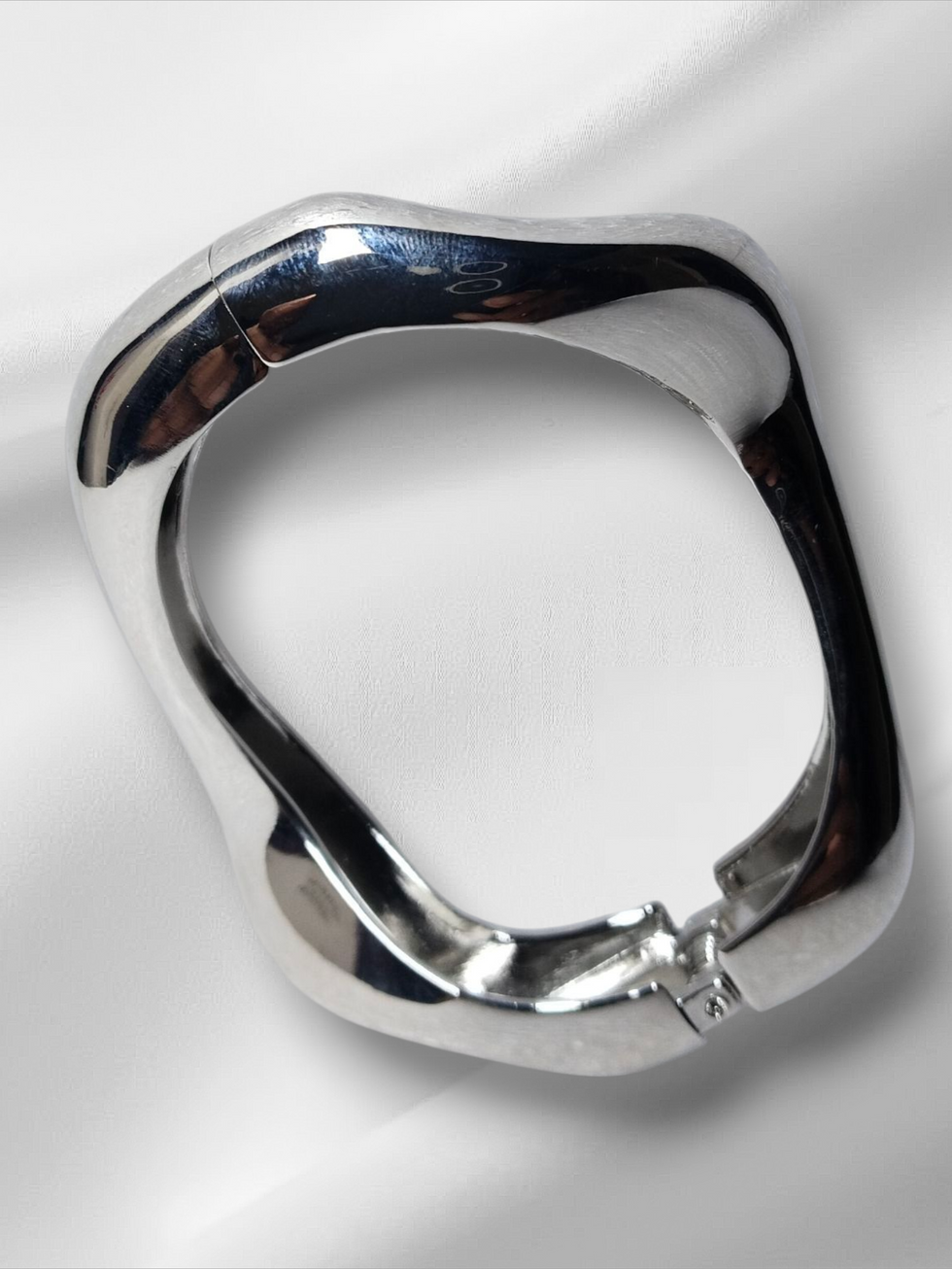 Silver Thin size openable Kada on a white cloth, Lavish Jewellery.