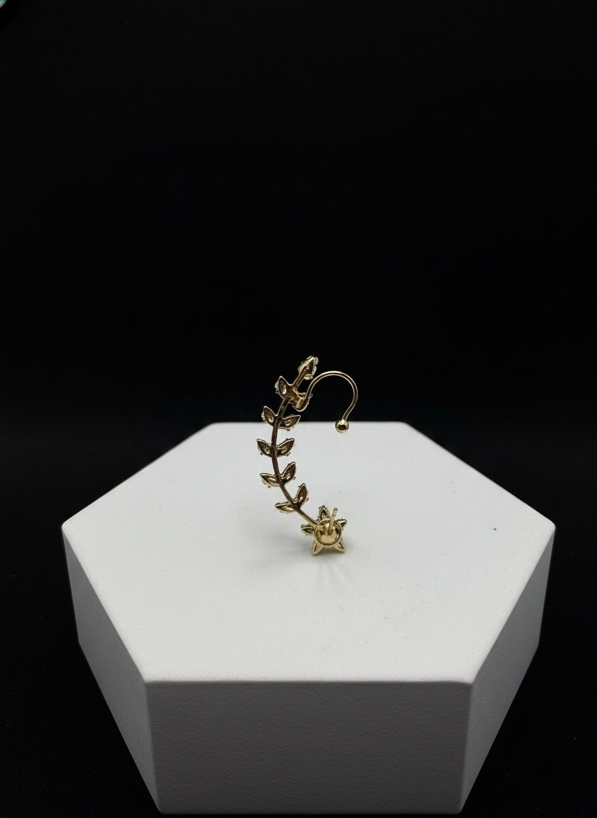 Golden leaf-shaped ear cuff displayed on a white surface, Lavish Jewellery.