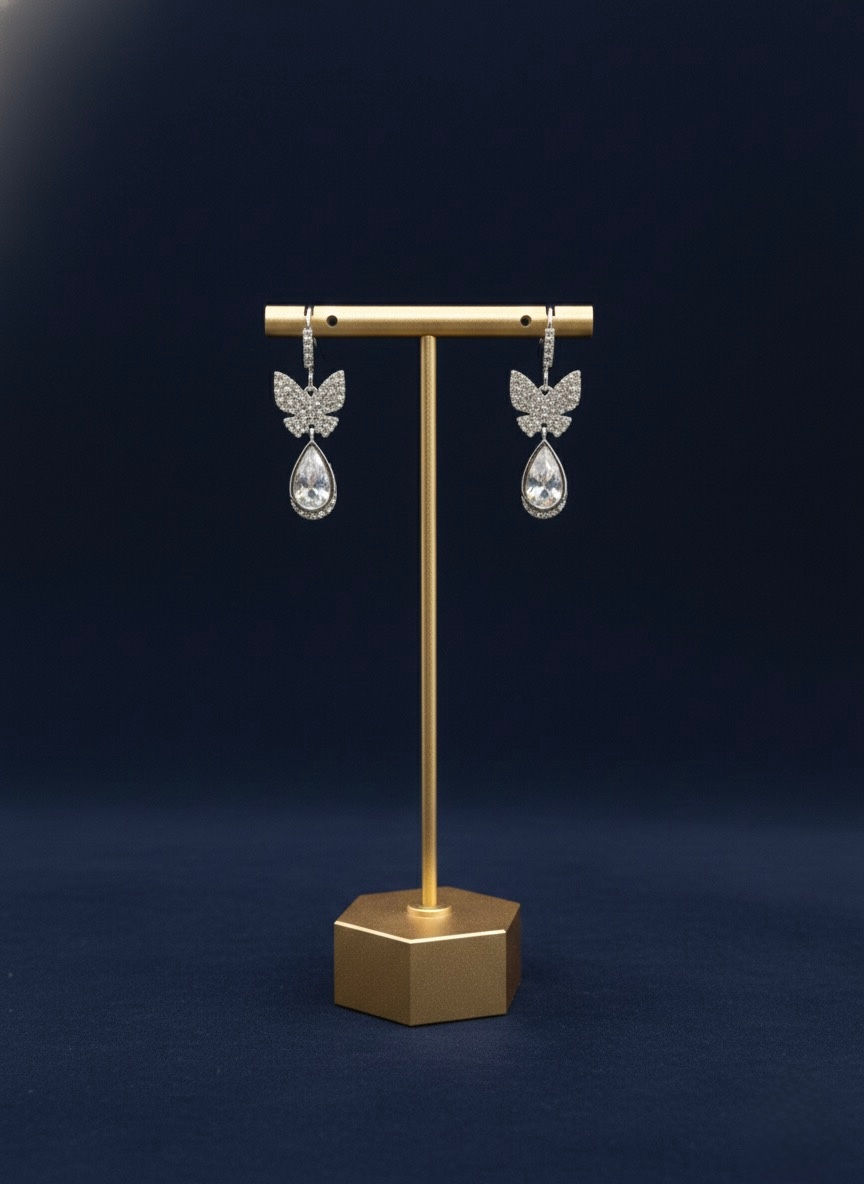 Butterfly earrings on display stand. Lavish Jewellery displayed against a dark background.