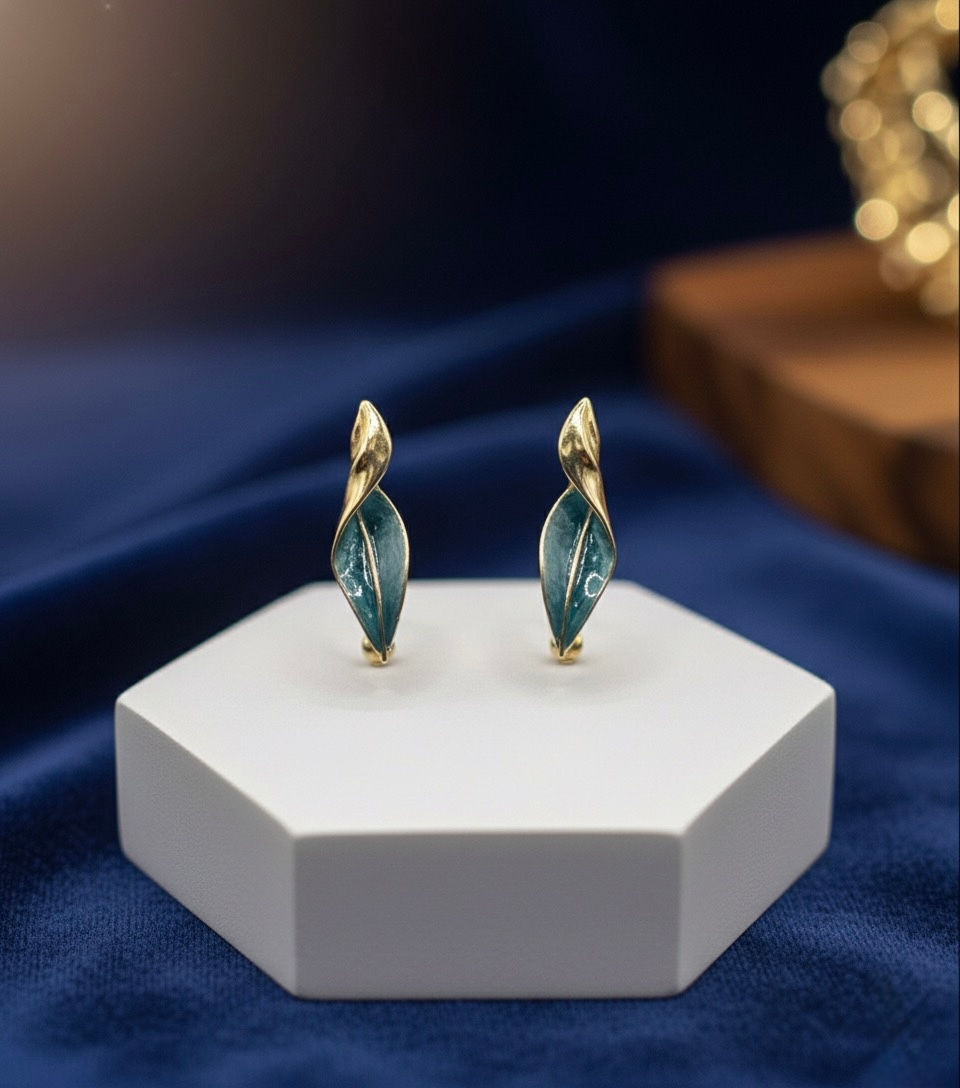 Elegant teal and gold earrings on display, Lavish Jewellery on a white stage.