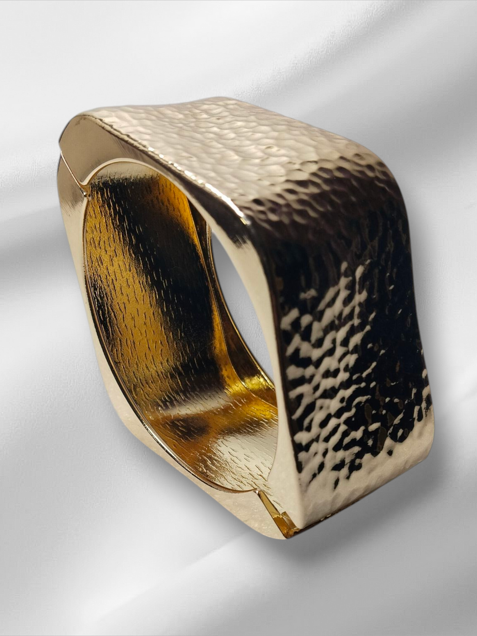 Golden square-shaped bracelet on a white background, Lavish Jewellery.