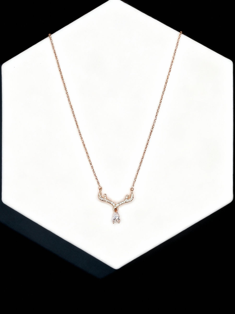 Rose gold necklace on a white surface, elegant Lavish Jewellery display.
