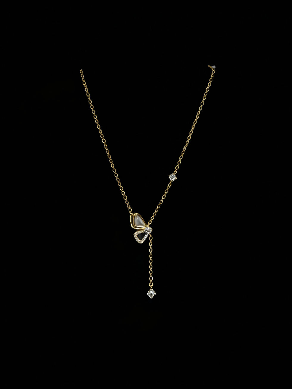 Elegant gold pendant necklace with diamonds, shining against black background. Lavish Jewellery