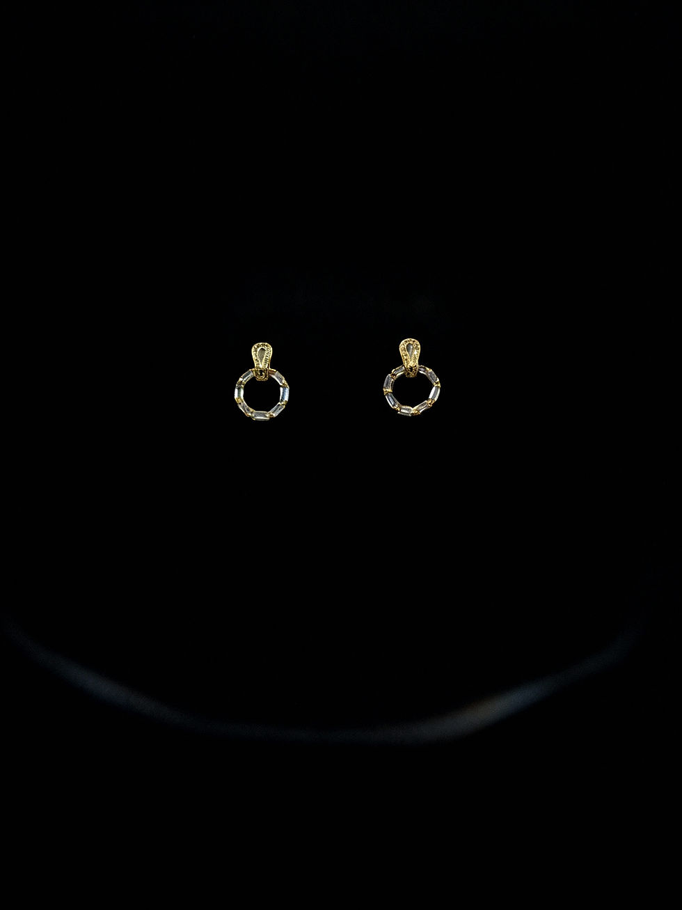Pair of gold earrings, Zirconia Gold Colour Earring, elegant design on black background, Lavish Jewellery