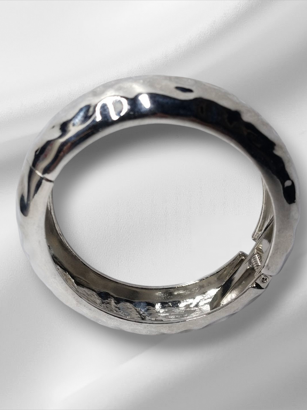 Silver hammered bracelet on a white background, Lavish Jewellery.