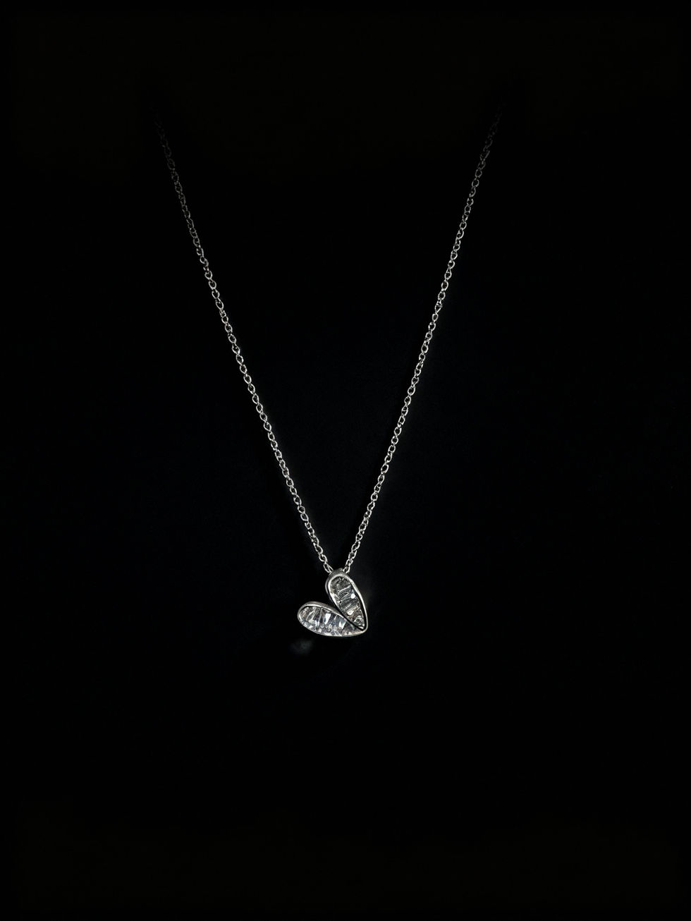 Heart pendant necklace on a black background. Pearl Ribbon Pendant Necklace. Lavish Jewellery.